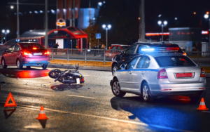 a damaged motorcycle with riding passenger vehicles in the background