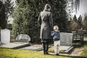 a mother and her son at their father's gravesite following his fatal incident and criminal prosecution