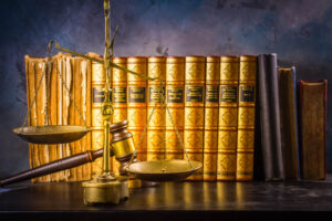 Law and justice concept - law gavel and scale with row of books, retro toned