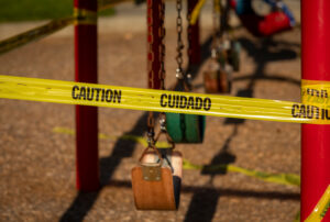 a swing set surrounded by caution tape.