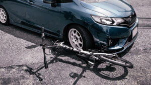 a bicycle under a car after an accident