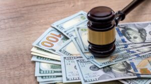 a gavel with money to help recover compensation