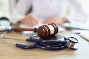 Las Vegas medical malpractice lawyer writing notes with gavel and stethoscope on desk