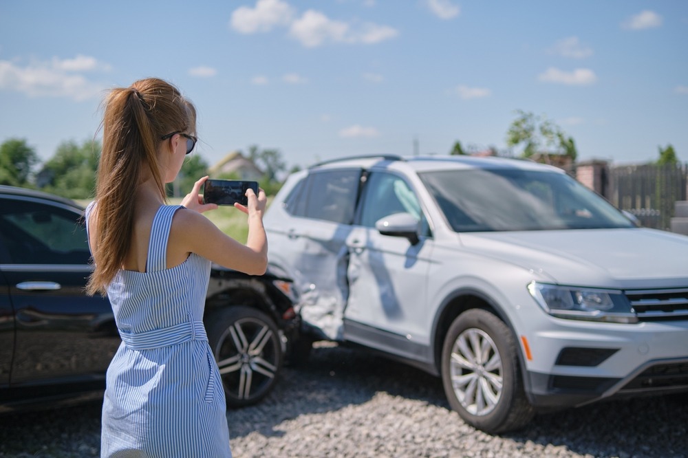 woman taking picture of accident as evidence for Las Vegas Uber accident lawyer to file personal injury claim